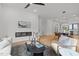 Bright, modern living room with fireplace, ceiling fan, and lots of natural light at 512 Edgecreek Ct, Raleigh, NC 27604