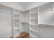 Spacious walk-in closet features custom shelving, wooden rods and hardwood floors at 512 Edgecreek Ct, Raleigh, NC 27604