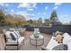 Rooftop deck features outdoor seating with cozy pillows and cushions at 513 Edgecreek Ct, Raleigh, NC 27604