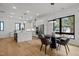 An open-concept kitchen with white cabinetry, stainless steel appliances and a dining area at 515 Edgecreek Ct, Raleigh, NC 27604