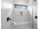 Luxurious glass shower with marble tile, built-in bench, and recessed shelving at 515 Edgecreek Ct, Raleigh, NC 27604