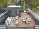 Aerial view of rooftop deck featuring outdoor furnishings, trees, and street view at 516 Edgecreek Ct, Raleigh, NC 27604
