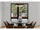 Modern dining area featuring stylish light fixture, furniture, and large windows at 516 Edgecreek Ct, Raleigh, NC 27604