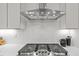Modern kitchen with stainless steel range hood and white subway tile backsplash at 516 Edgecreek Ct, Raleigh, NC 27604