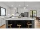 Gourmet kitchen with an island, stylish bar stools, and stainless steel appliances at 516 Edgecreek Ct, Raleigh, NC 27604