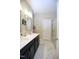 Bathroom featuring a double vanity with modern fixtures, and a walk-in shower with glass doors at 547 Historic Dr, Hillsborough, NC 27278
