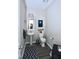 Half bathroom featuring a pedestal sink, framed mirror and art on the wall at 547 Historic Dr, Hillsborough, NC 27278