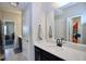 Modern bathroom featuring a dark vanity and a bright countertop and a door leading to another room at 547 Historic Dr, Hillsborough, NC 27278