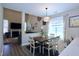 Cozy dining area with wood table and a view to the living room and fireplace at 547 Historic Dr, Hillsborough, NC 27278