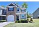 Well-maintained townhome featuring a combination of brick and siding, complemented by a neatly landscaped front yard at 547 Historic Dr, Hillsborough, NC 27278