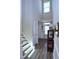 Bright foyer with a staircase features a neutral color palette and durable wood flooring at 547 Historic Dr, Hillsborough, NC 27278
