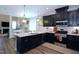 This modern kitchen features dark cabinetry, stainless steel appliances, and stylish pendant lighting at 547 Historic Dr, Hillsborough, NC 27278