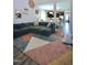 Cozy living room featuring a green sectional, hardwood floors, and an open view to the kitchen and dining areas at 547 Historic Dr, Hillsborough, NC 27278