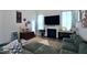 Inviting living room with a fireplace, entertainment center, and a cozy green sectional couch at 547 Historic Dr, Hillsborough, NC 27278