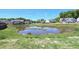 Neighborhood pond surrounded by residential buildings at 547 Historic Dr, Hillsborough, NC 27278