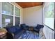 Screened-in porch with wicker seating and wood paneled ceiling at 547 Historic Dr, Hillsborough, NC 27278