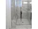 Modern bathroom with a frameless glass shower, marble walls, and a built-in bench at 547 Historic Dr, Hillsborough, NC 27278