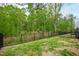 Grassy backyard with a black fence offers great outdoor enjoyment opportunities at 594 Historic Dr, Hillsborough, NC 27278