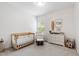 Bright Bedroom with neutral tones, a wooden crib, and a comfortable rocking chair at 594 Historic Dr, Hillsborough, NC 27278