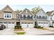 Charming townhouses with a brick and siding exterior and attached one-car garages at 594 Historic Dr, Hillsborough, NC 27278