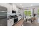 Well-equipped kitchen with modern appliances, granite counters, and access to the patio at 594 Historic Dr, Hillsborough, NC 27278