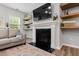 Cozy living room with fireplace, stylish decor, and ample natural light at 594 Historic Dr, Hillsborough, NC 27278