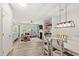 Open-concept living space with modern furnishings, fireplace, and seamless flow to dining area at 594 Historic Dr, Hillsborough, NC 27278