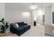 Loft area featuring a comfortable navy sectional sofa, soft carpet, and light gray walls at 594 Historic Dr, Hillsborough, NC 27278