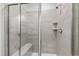 Shower stall featuring gray tiling, a built-in bench, and a rainfall shower head at 594 Historic Dr, Hillsborough, NC 27278