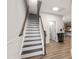 Elegant staircase with hardwood steps, white risers, and a natural wood banister at 594 Historic Dr, Hillsborough, NC 27278