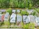 An aerial view of the charming homes nestled among lush green trees along a quiet street at 607 Millbrook Dr, Pittsboro, NC 27312