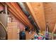 Attic with exposed rafters and several items stored inside at 607 Millbrook Dr, Pittsboro, NC 27312