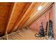 Attic featuring exposed rafters, insulation and stored equipment at 607 Millbrook Dr, Pittsboro, NC 27312