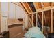 Attic featuring exposed rafters, storage items and a variety of insulation materials at 607 Millbrook Dr, Pittsboro, NC 27312