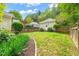 Lush backyard with a stone pathway to a matching guest house at 607 Millbrook Dr, Pittsboro, NC 27312