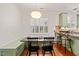 Inviting dining area with a built-in bench, modern light fixture, and access to the kitchen at 607 Millbrook Dr, Pittsboro, NC 27312