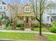 Charming two-story home with a brick porch, landscaped yard, and an American flag waving proudly at 607 Millbrook Dr, Pittsboro, NC 27312