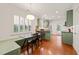 Well-lit kitchen with stainless steel appliances, green cabinets, and an adjacent dining area with lots of light at 607 Millbrook Dr, Pittsboro, NC 27312