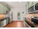 Well-lit kitchen with stainless steel appliances and access to backyard at 607 Millbrook Dr, Pittsboro, NC 27312