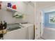 Laundry room featuring a washer, a dryer and storage shelves at 607 Millbrook Dr, Pittsboro, NC 27312