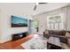 Comfortable living room featuring hardwood floors, a TV, a modern entertainment center and a couch at 607 Millbrook Dr, Pittsboro, NC 27312