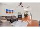 Comfortable living room with hardwood floors, a fireplace, and an open view to the dining area and kitchen at 607 Millbrook Dr, Pittsboro, NC 27312