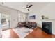 Bright living room featuring hardwood floors, a fireplace, a comfortable couch and an exterior door at 607 Millbrook Dr, Pittsboro, NC 27312