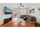 Cozy living room with hardwood floors, a modern entertainment center, and an exterior view at 607 Millbrook Dr, Pittsboro, NC 27312