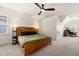 Bright main bedroom with ceiling fan, carpet, and views of the backyard at 607 Millbrook Dr, Pittsboro, NC 27312