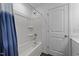Clean bathroom featuring white tub with shower and white door at 608 Creekway Dr, Fuquay Varina, NC 27526