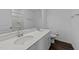 Bright bathroom featuring double sinks, quartz countertops, and a large mirror at 608 Creekway Dr, Fuquay Varina, NC 27526