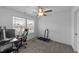 Simple bedroom with carpet, ceiling fan, a computer desk and treadmill, providing a relaxing and functional space at 608 Creekway Dr, Fuquay Varina, NC 27526