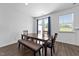 Bright dining room featuring wood table and bench, with natural light from the windows and French doors at 608 Creekway Dr, Fuquay Varina, NC 27526
