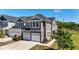 Charming townhome with gray siding, stone accents, and a two-car garage in a serene neighborhood at 608 Creekway Dr, Fuquay Varina, NC 27526